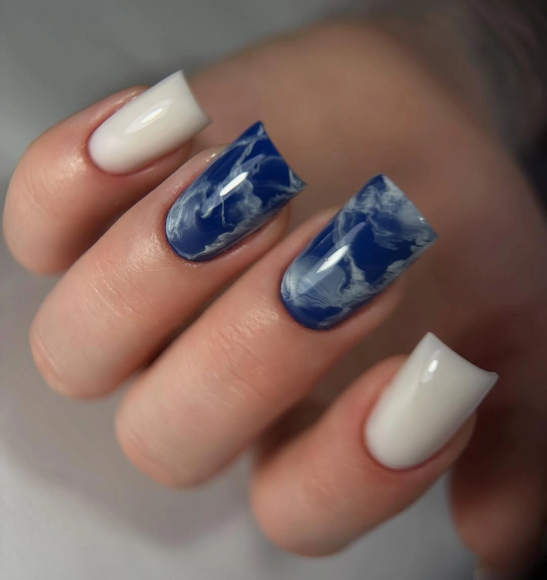 Medium nails with creamy white and navy abstract marbling