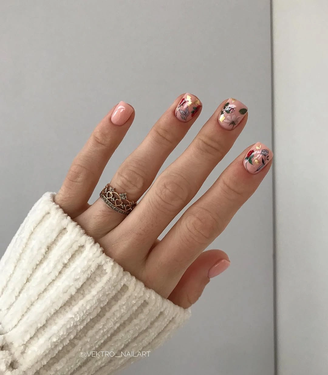 Short nude nails with tiny multicolor abstract and metallic accents