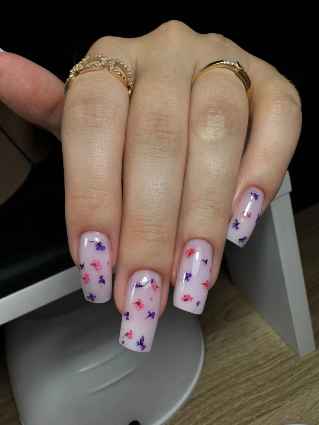 Long square translucent lilac nails with small purple flowers