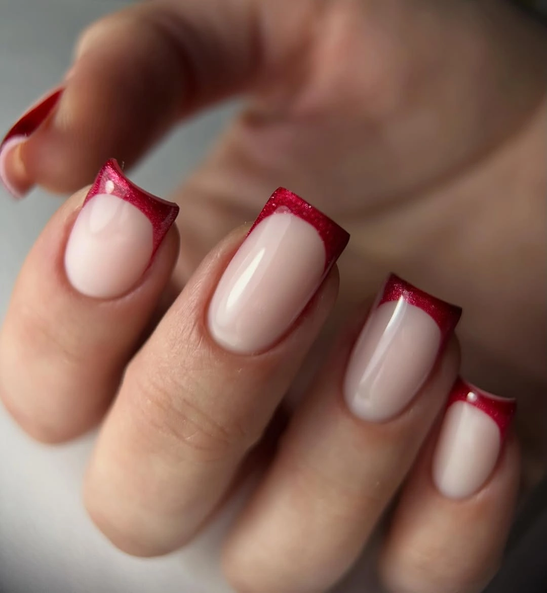 Short square nude nails with deep raspberry angled French tips