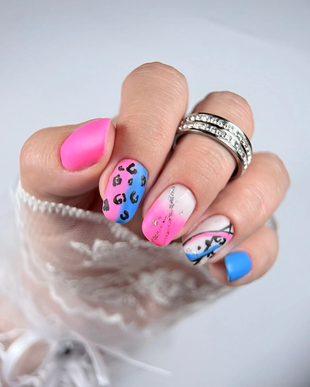 Long tapered nails with hot pink, spots, line art, and blue accents