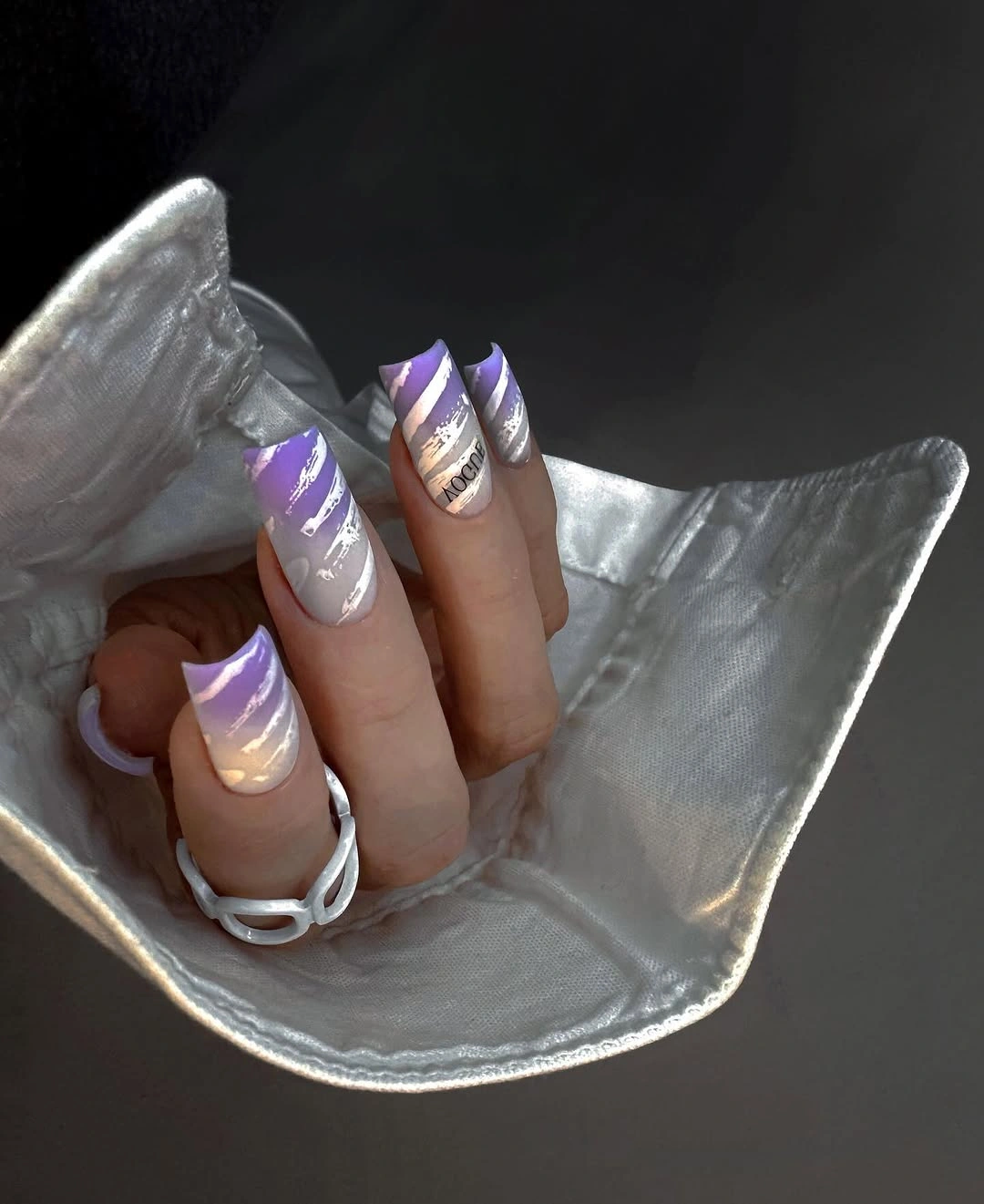 Long tapered nails with silver and lilac swirling accents