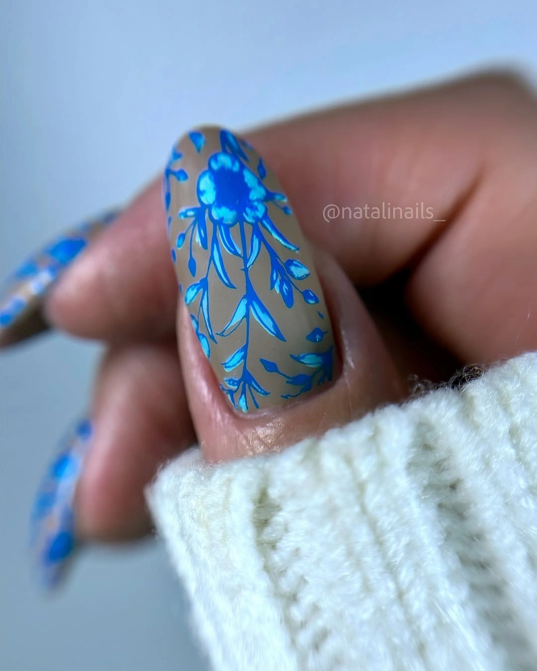 Cool gray-blue nail with bright blue floral linework