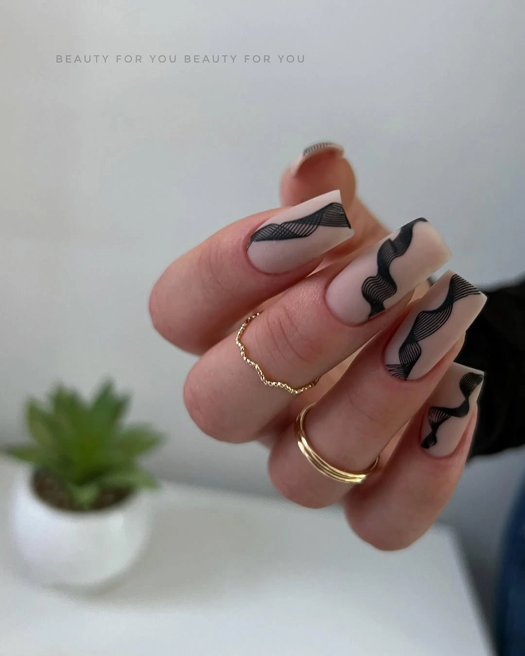 Pale almond nails with offset black geometric blocks