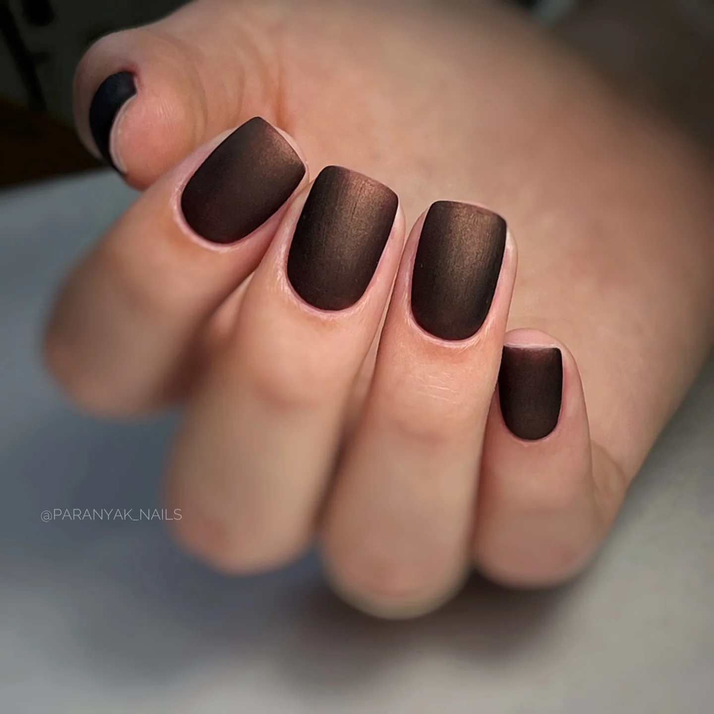Short rounded-square nails in a deep cocoa matte brown