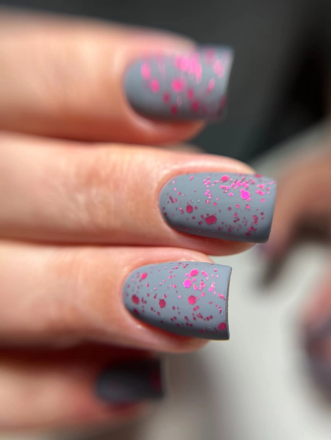 Cool gray square nails with scattered hot-pink flecks