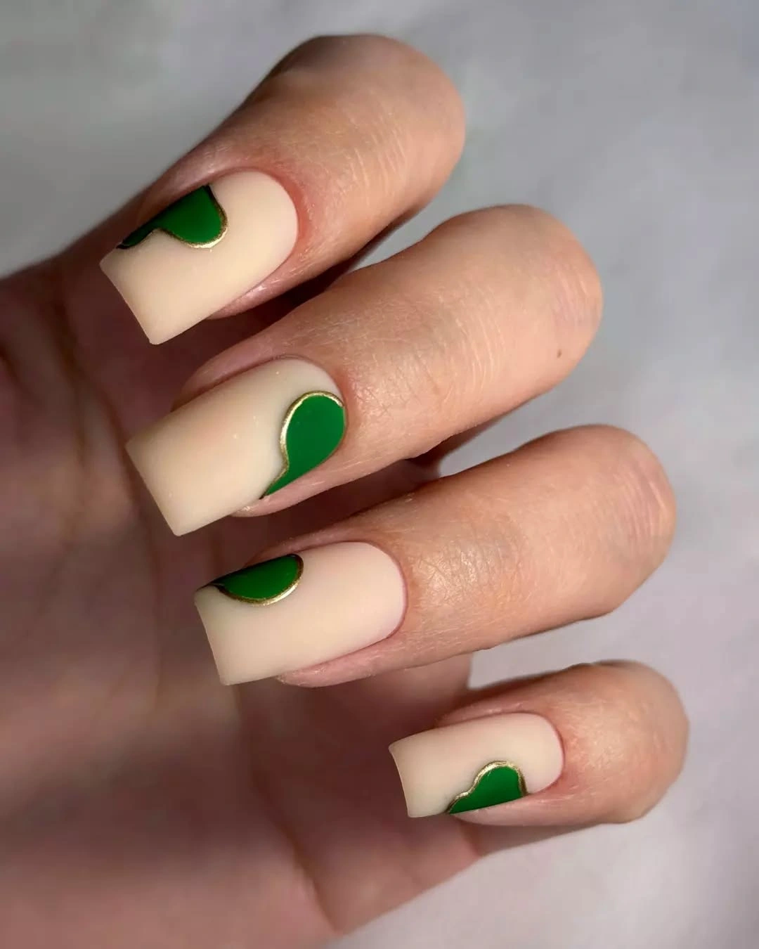 Cream square nails with curved green cuticle accents