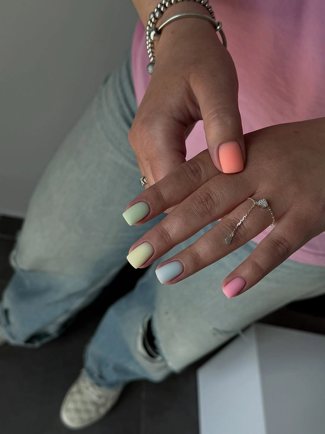 Muted blue pink and neutral nails on a compact shape