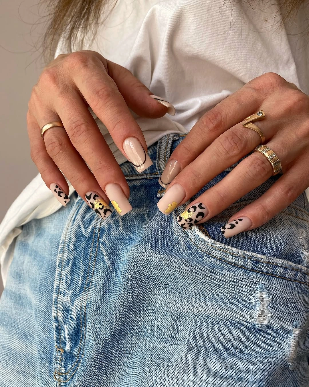 Mixed neutral almond nails with spotted print accents