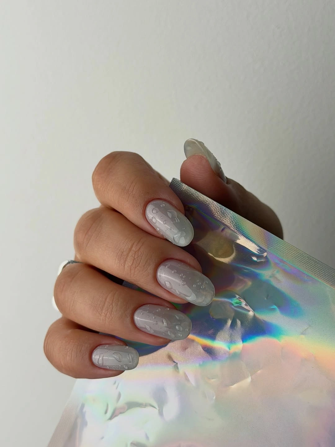 Long almond milky nails with blue violet and peach iridescent panels