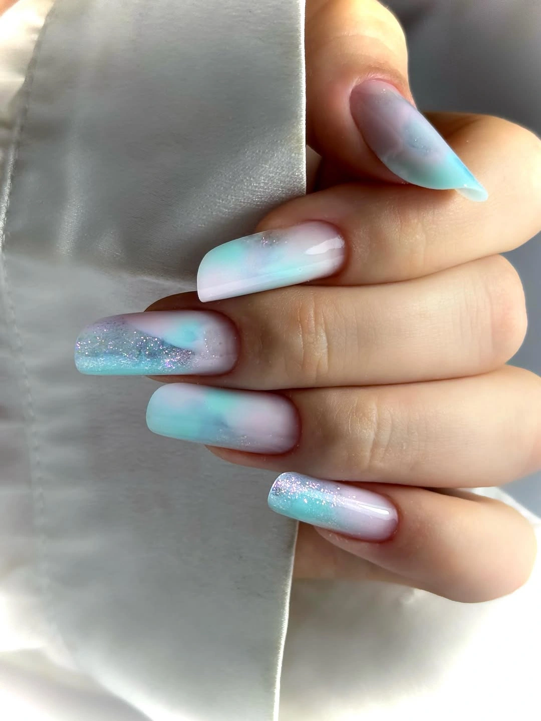 Long coffin nails blending pastel blue pink white and fine shimmer