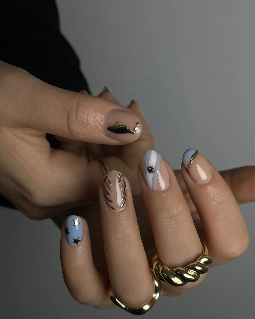 Soft square nails in taupe dusty blue white with tiny dark marks