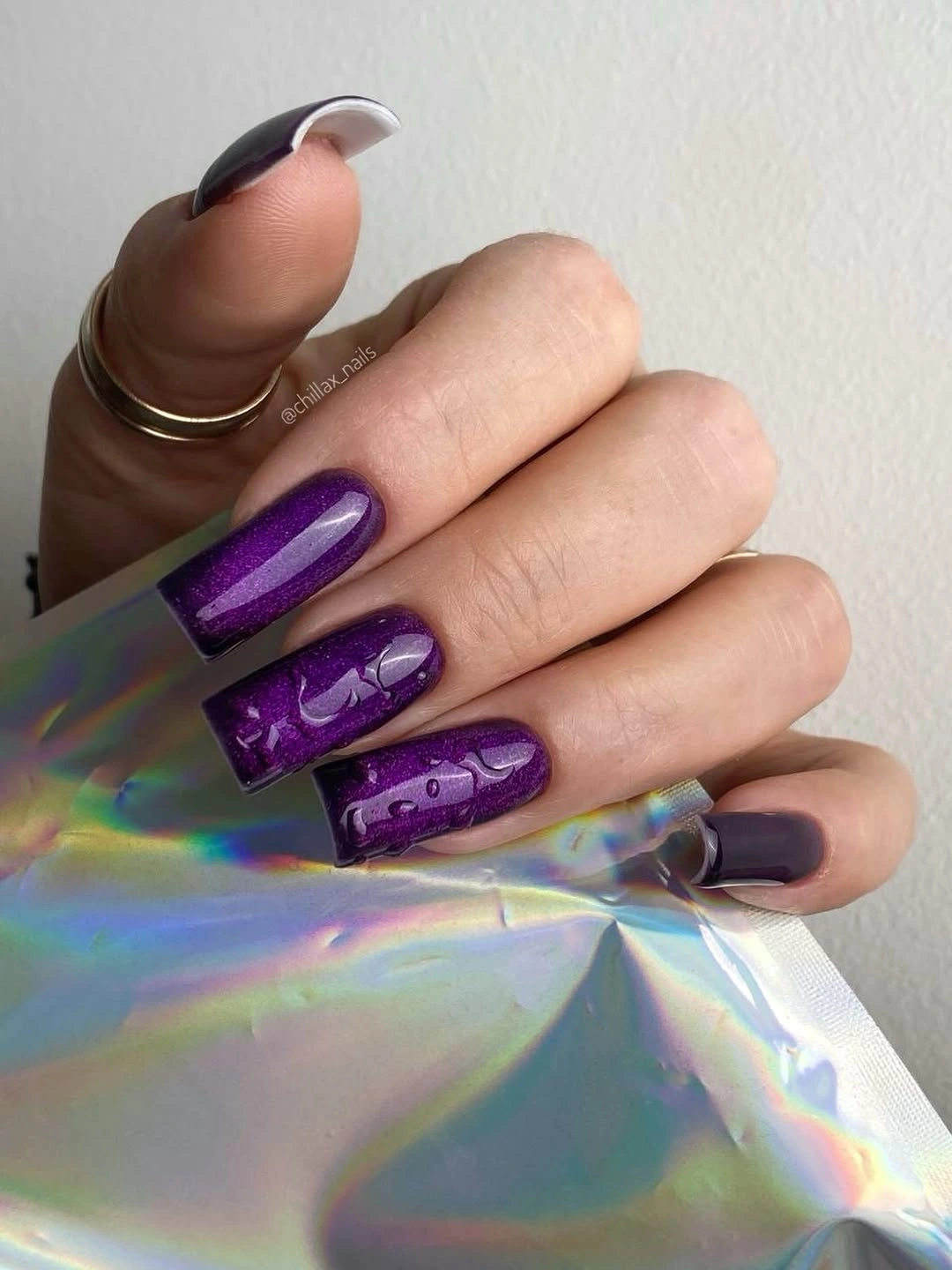 Long square vivid purple nails with dark reflective panels