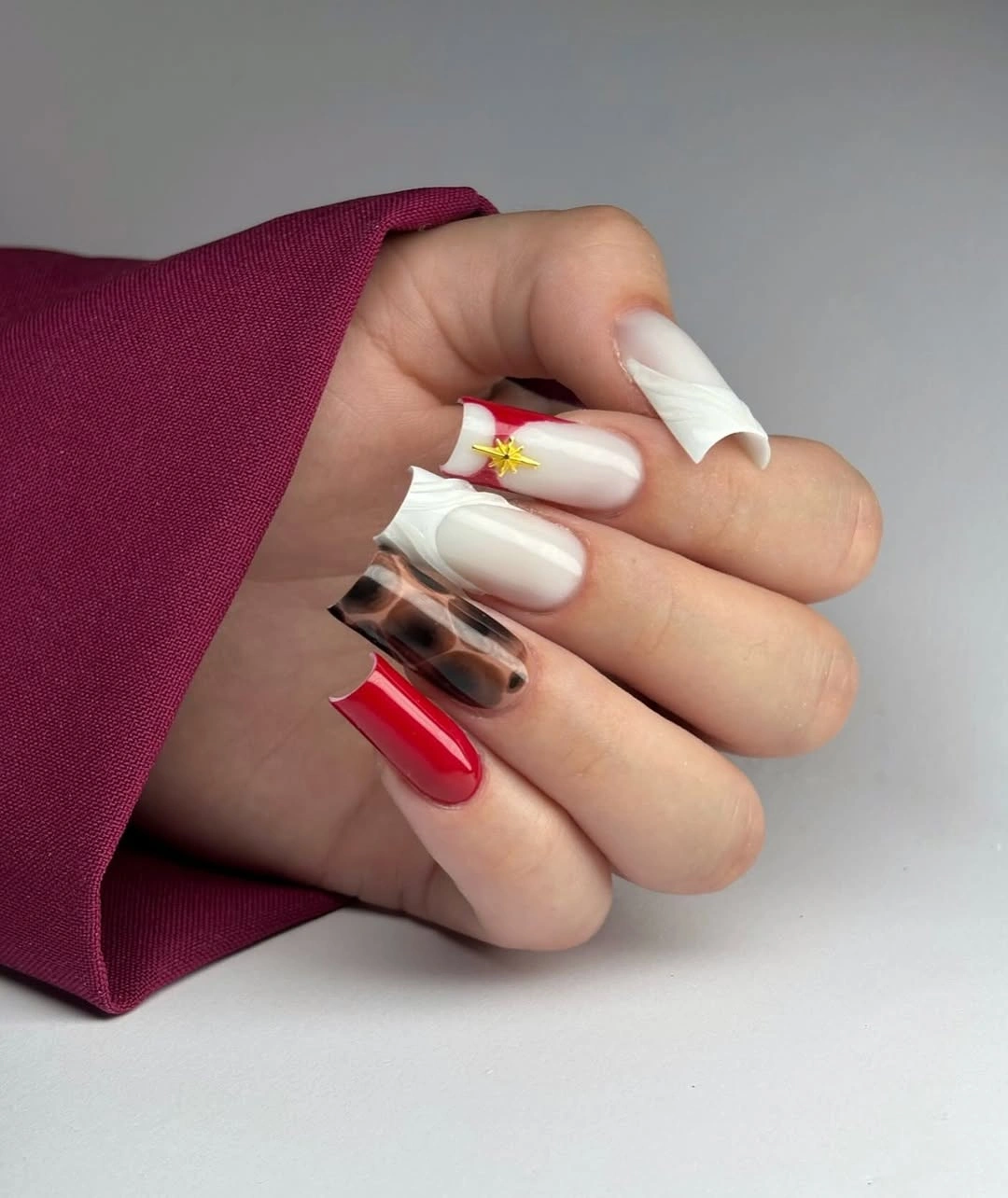 Long almond nails mixing milky white red and brown tortoiseshell accents