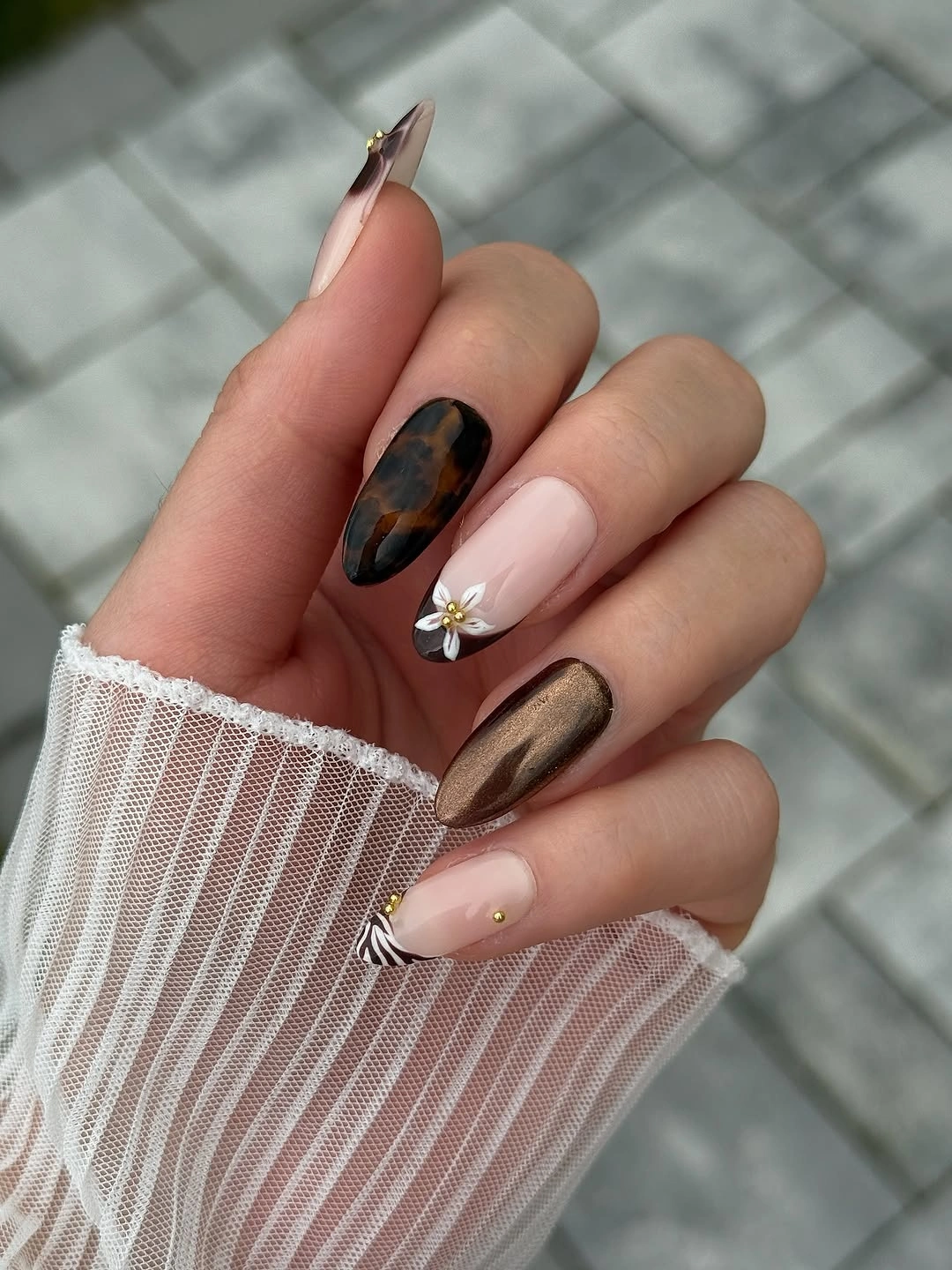 Long almond nails with tortoiseshell panels soft pink and tiny floral detail
