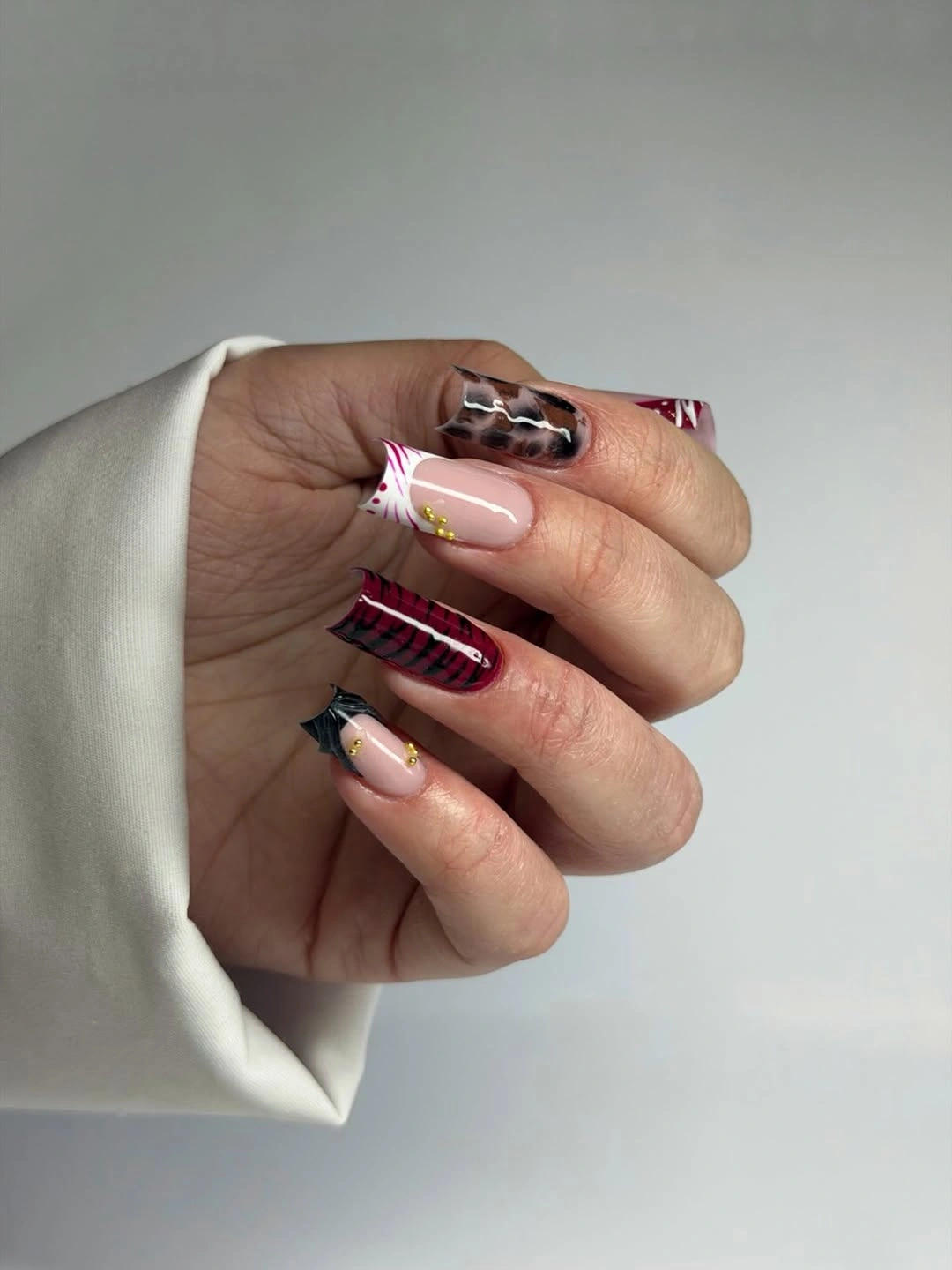 Long square nails with pale pink red plaid and black-white accents