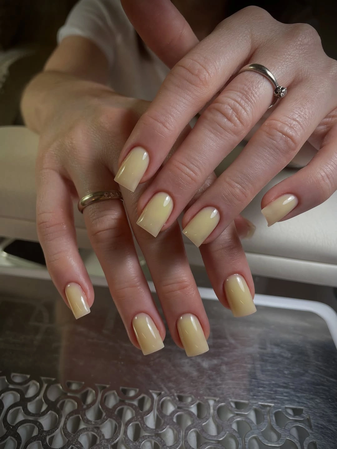 Medium square nails in a glossy creamy pale yellow