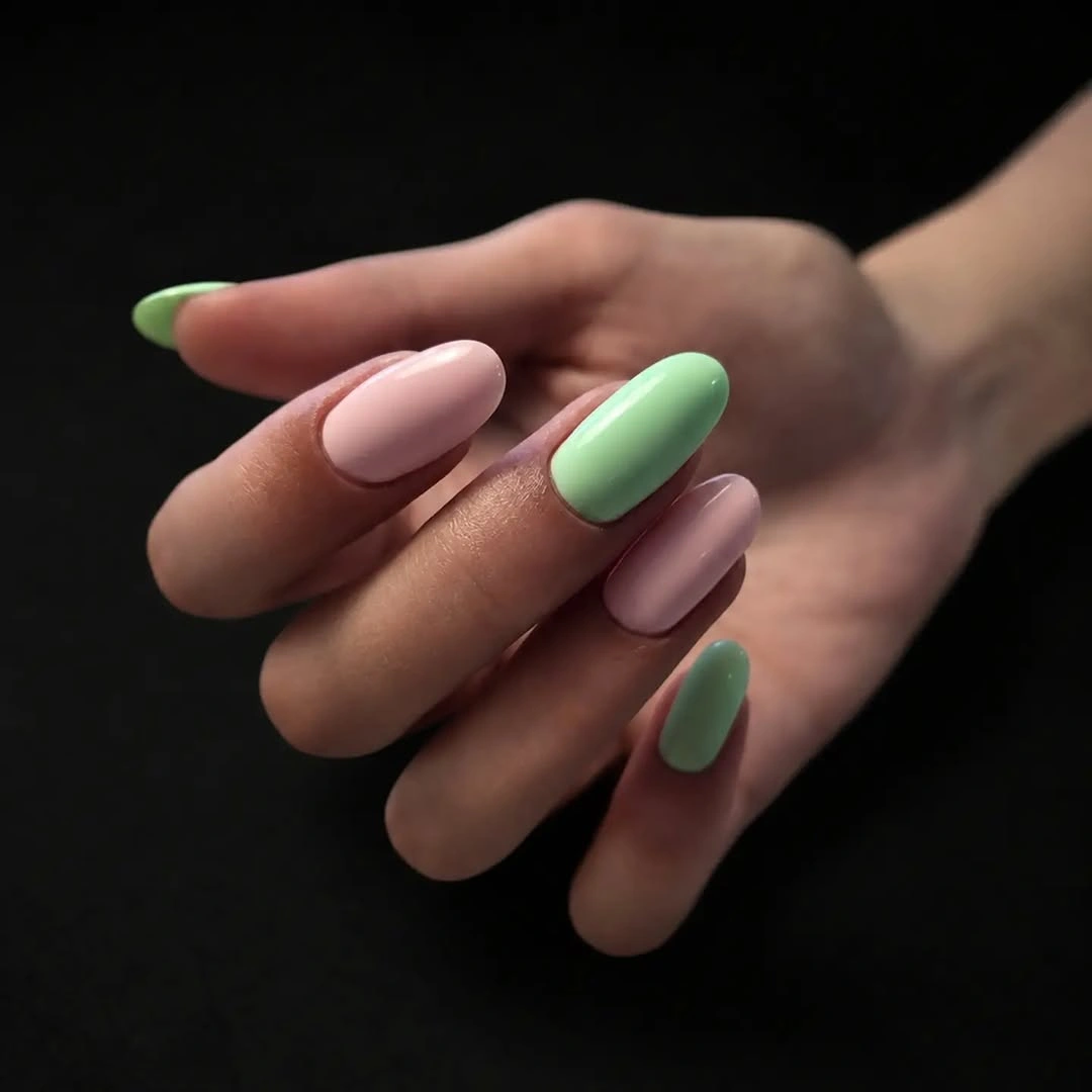 Medium almond nails alternating soft pink and pale mint green