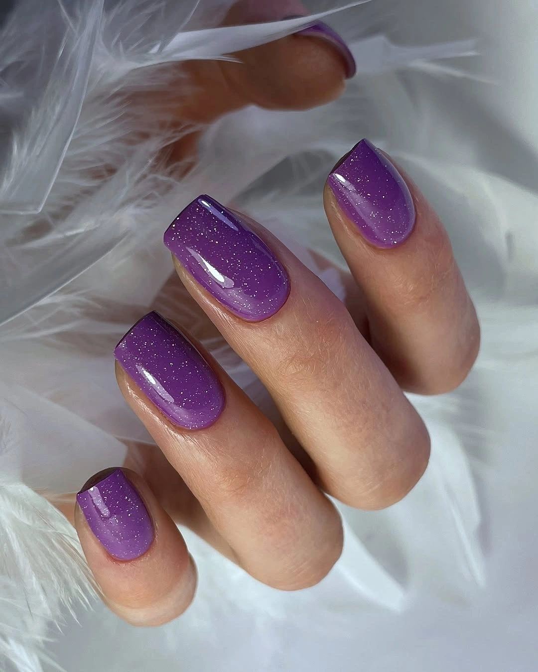 Short square nails in a glossy vivid purple