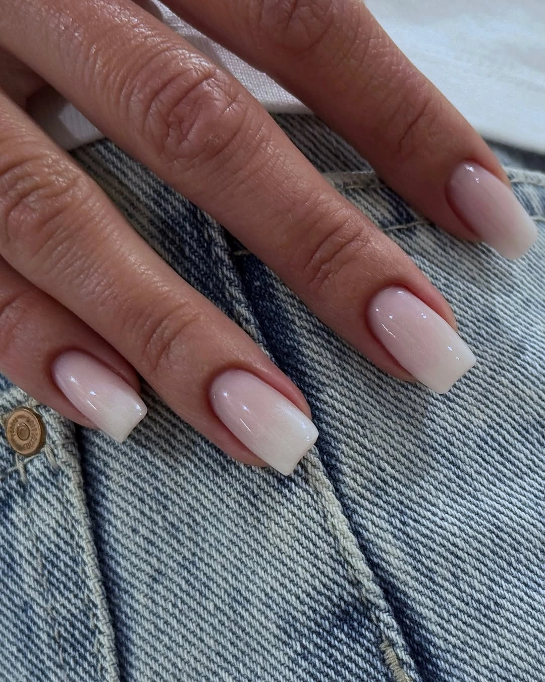 Medium square nails with sheer pink bases white French tips and bright pink accents