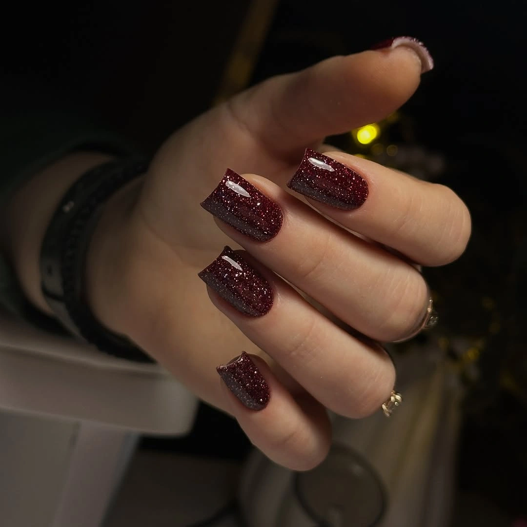Medium square nails with a glossy deep burgundy base and fine glitter