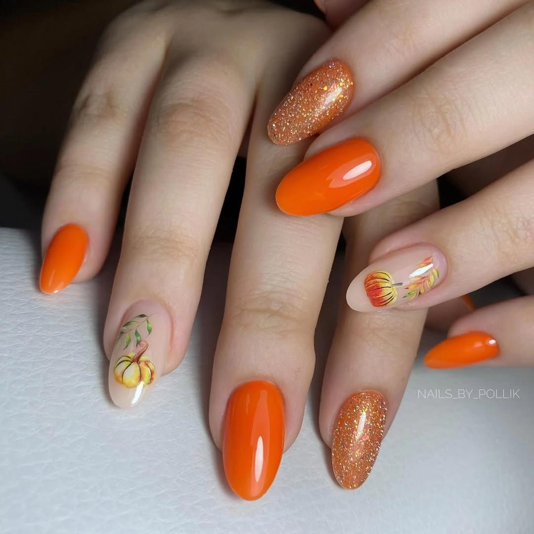 Medium almond orange nails mixing gloss glitter and small warm accents