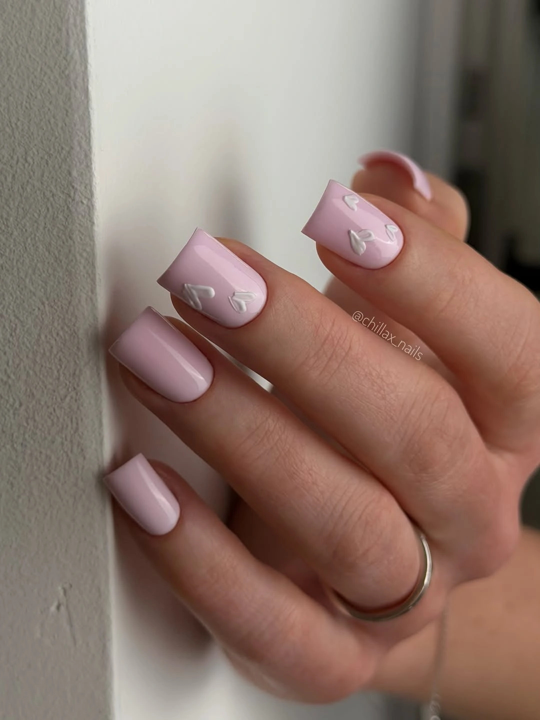 Short pink square nails with small pale tone-on-tone accents