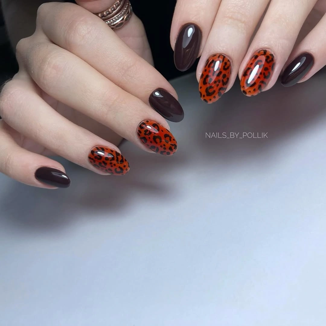Long almond black nails covered in dense silver glitter