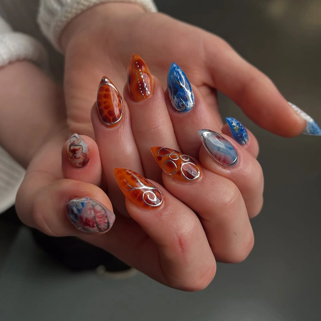pointed amber blue and silver mixed motif nails