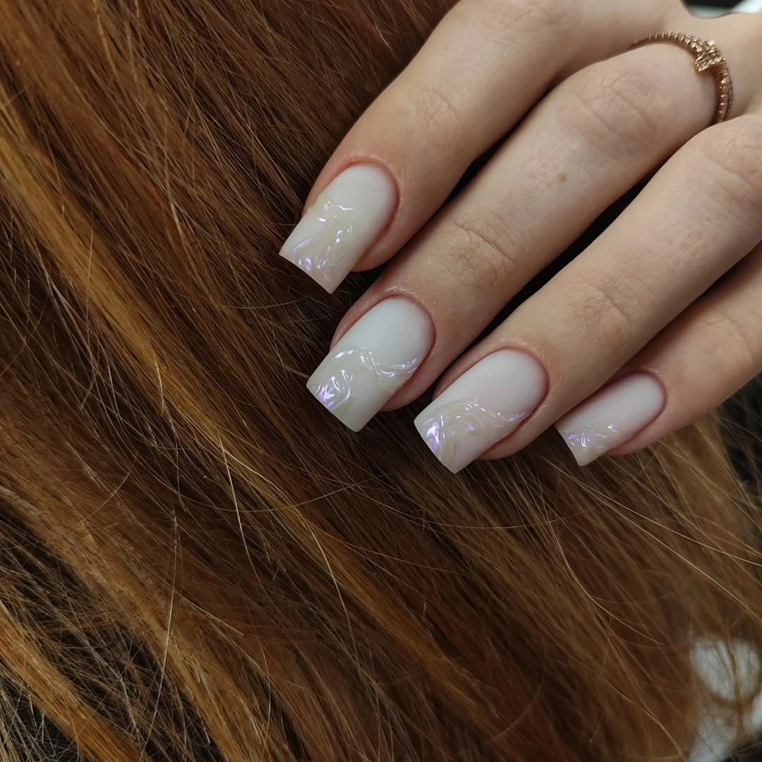 milky square nails with pearly swirl details