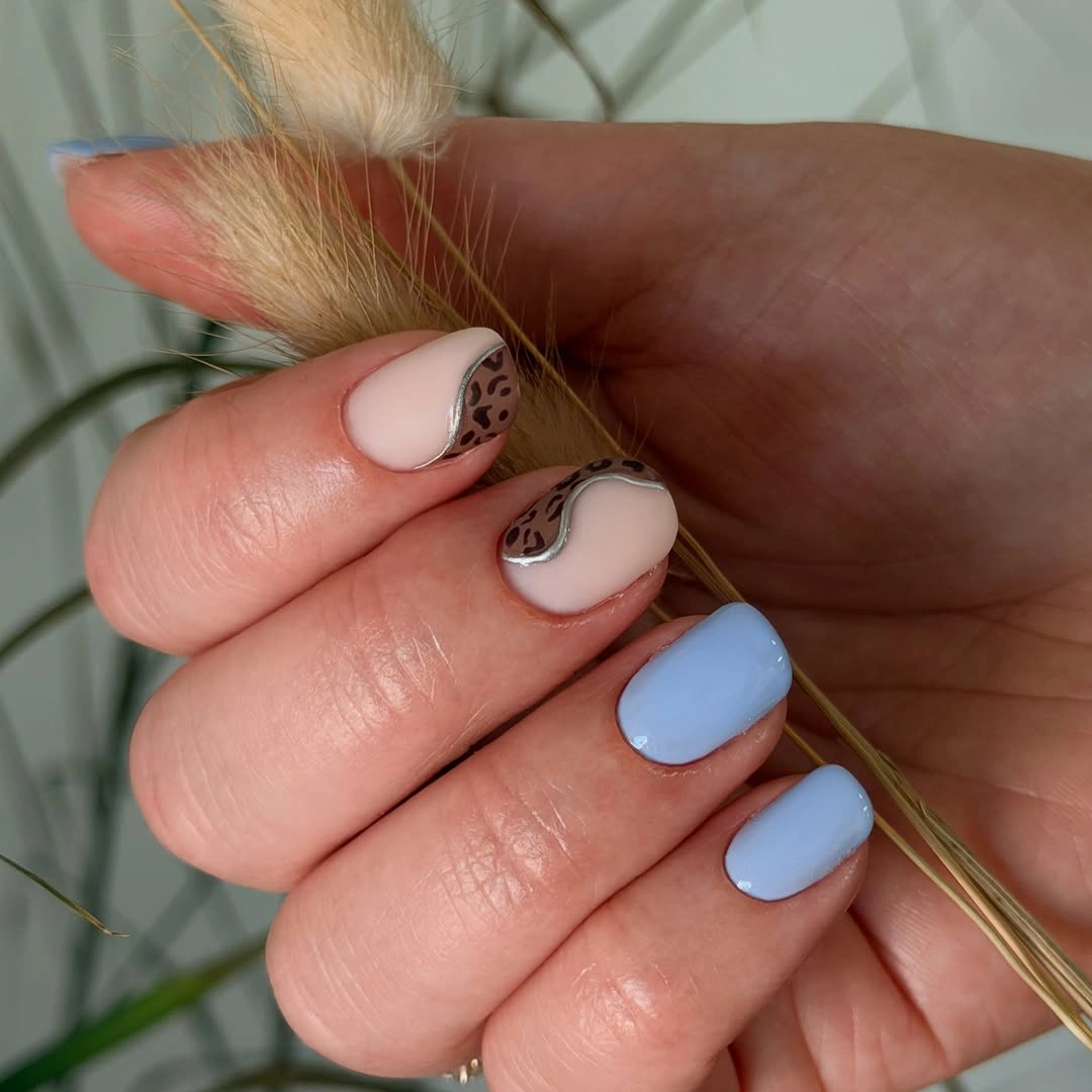 short pale blue nails with leopard tip accents