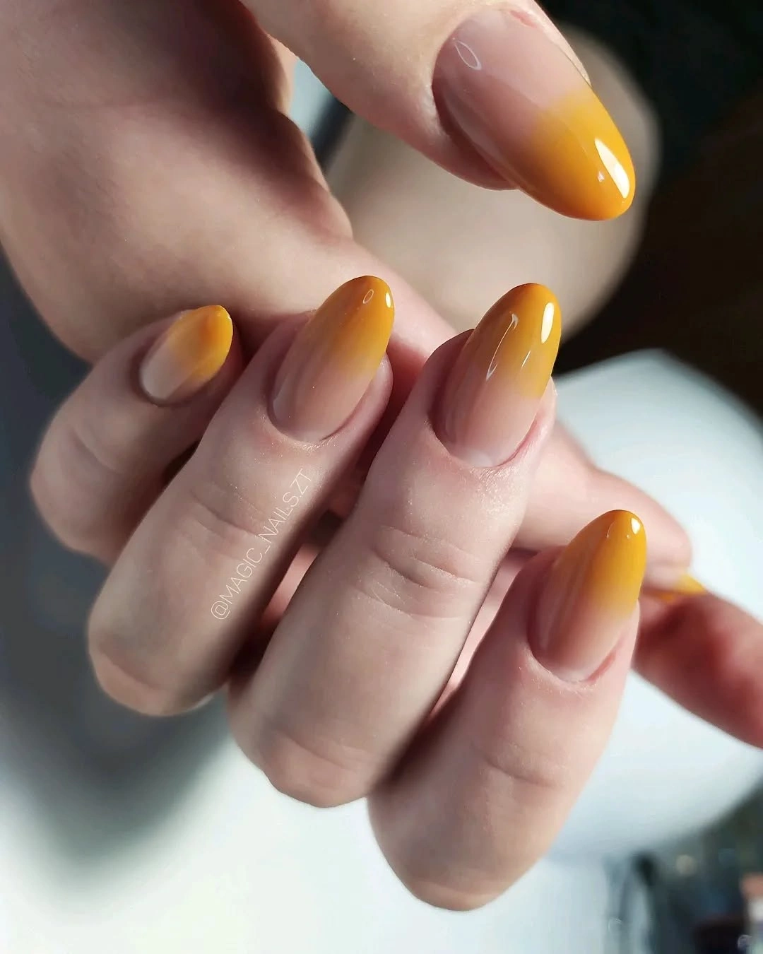 sheer almond nails with amber gradient tips
