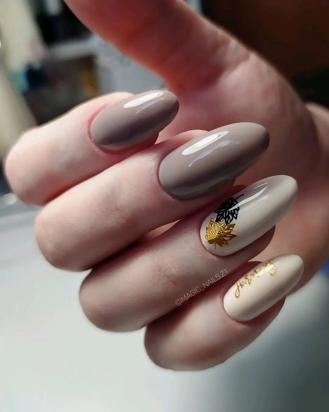 taupe almond nails with cream gold leaf accents