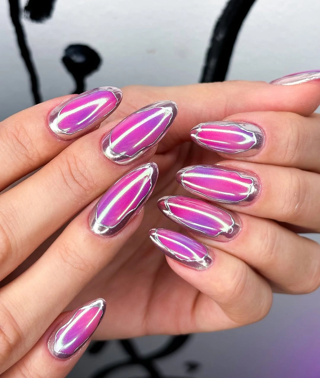 magenta almond nails with reflective silver borders