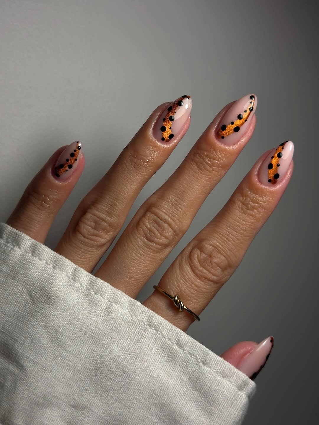 Medium almond nails with black tips gold dots and fine dark lines