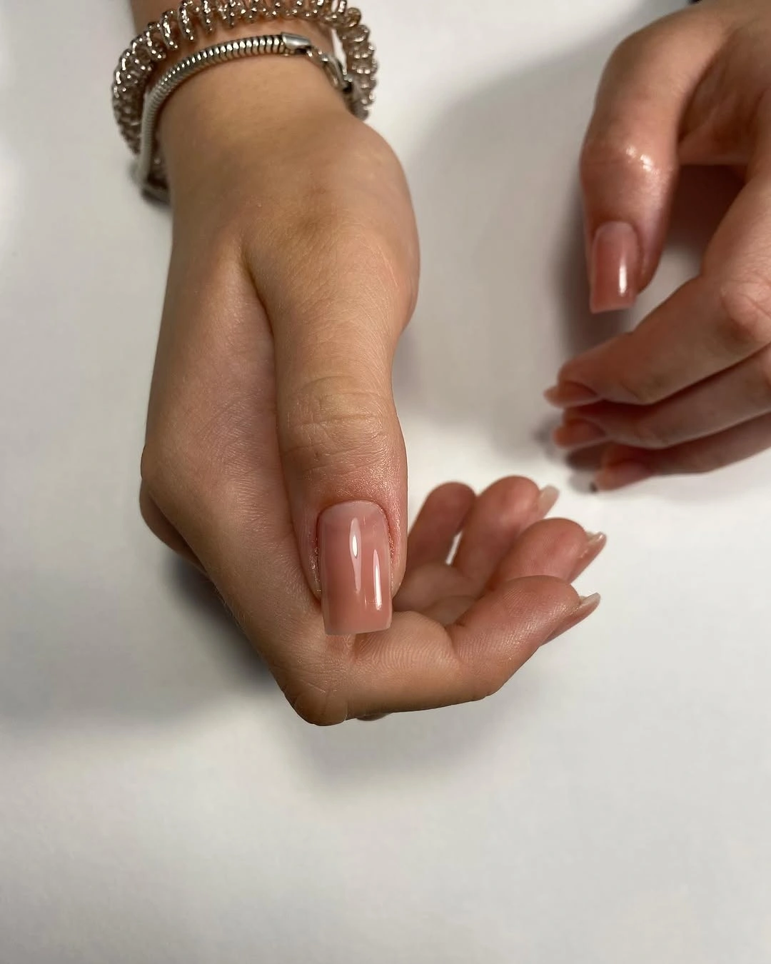 Short square nails in glossy translucent blush nude