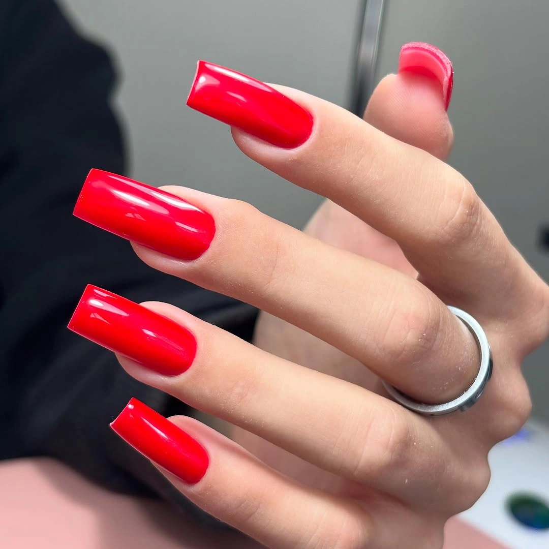 Long square nails in vivid glossy bright red polish