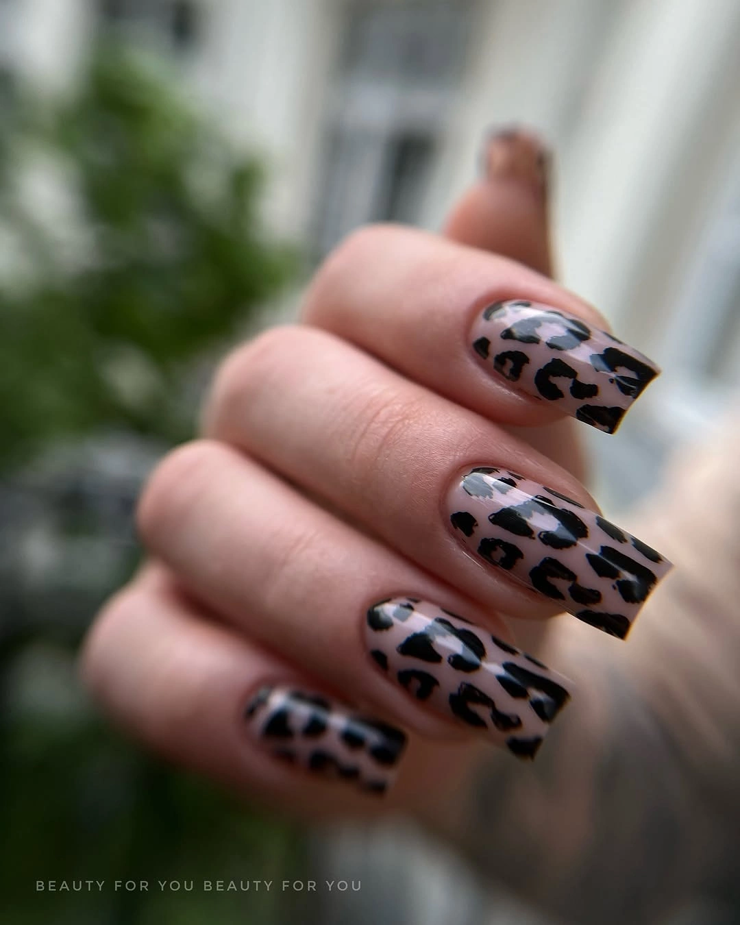 Medium square nails with black and taupe cow print accents