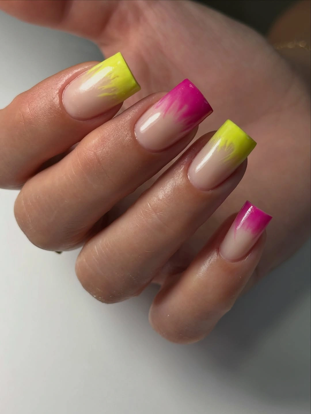 Short square nails with neon pink and lime French tips