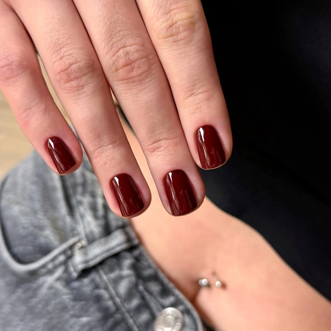 Short square nails in glossy deep burgundy polish