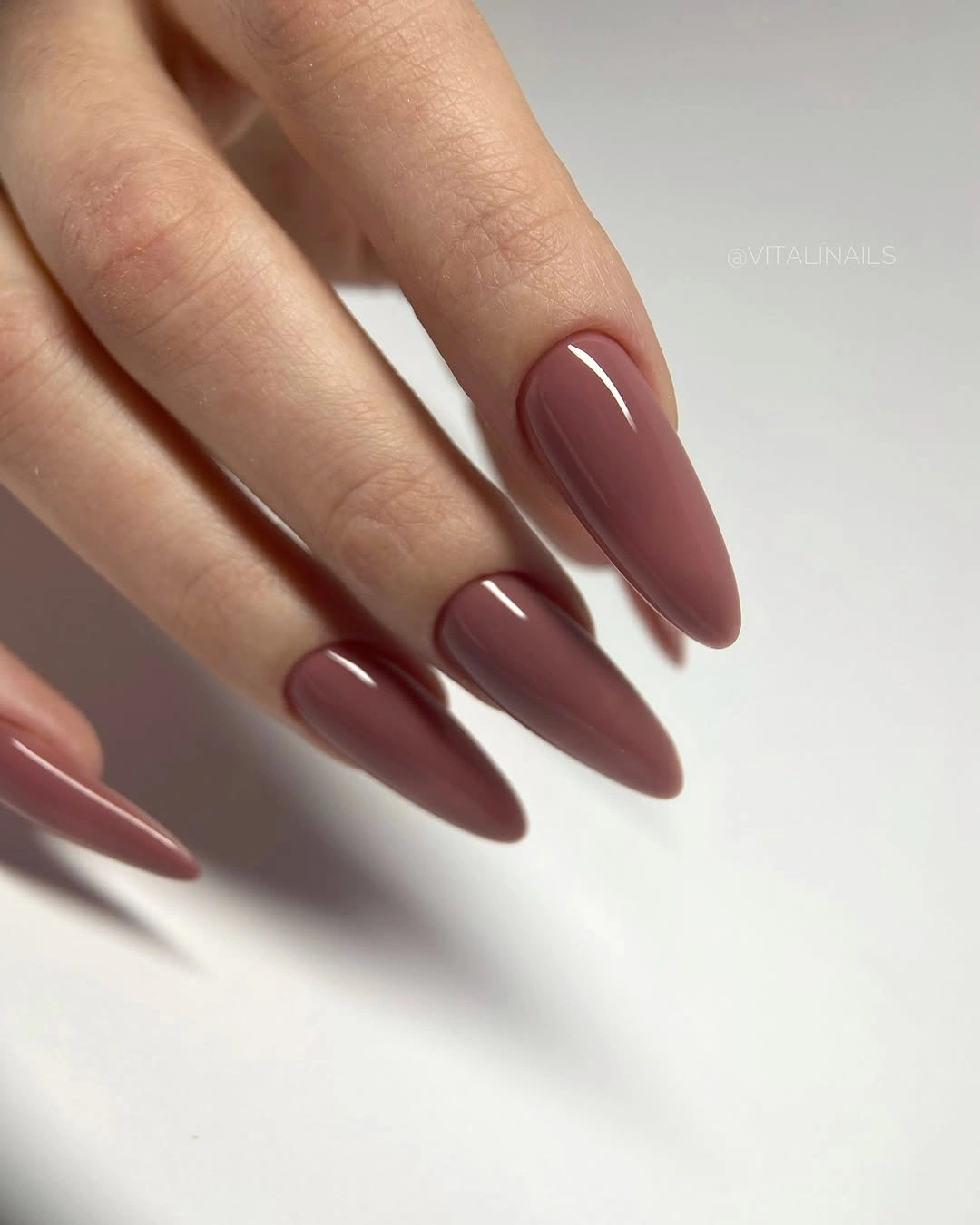 Long almond nails in deep glossy mauve wine