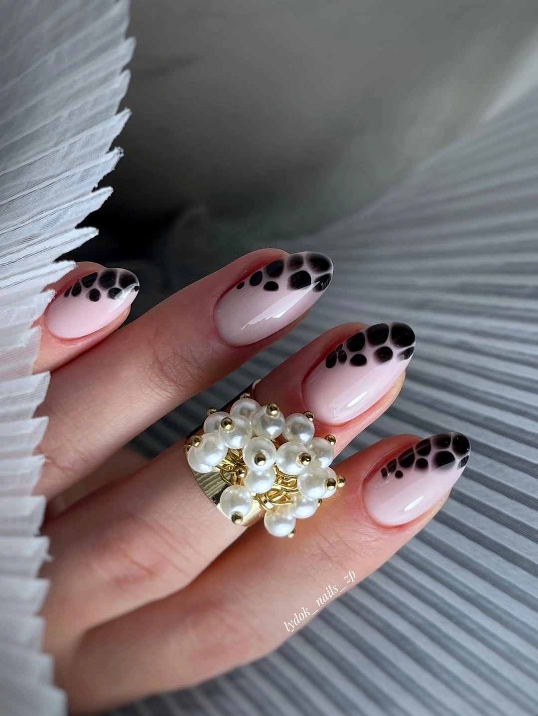 Long almond French nails with spotted tips and gold accent