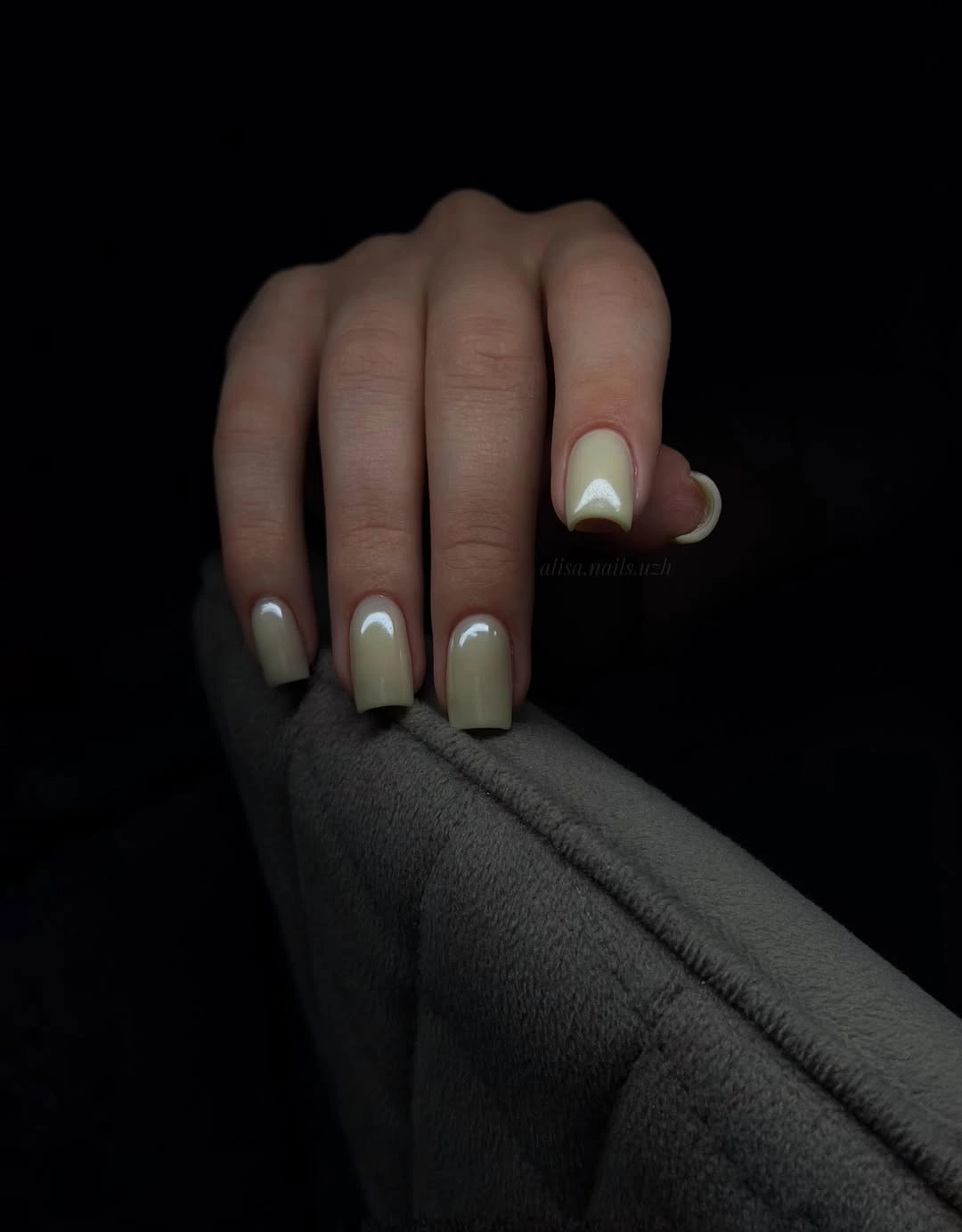 Short square nails in pale sage cream with a subtle accent