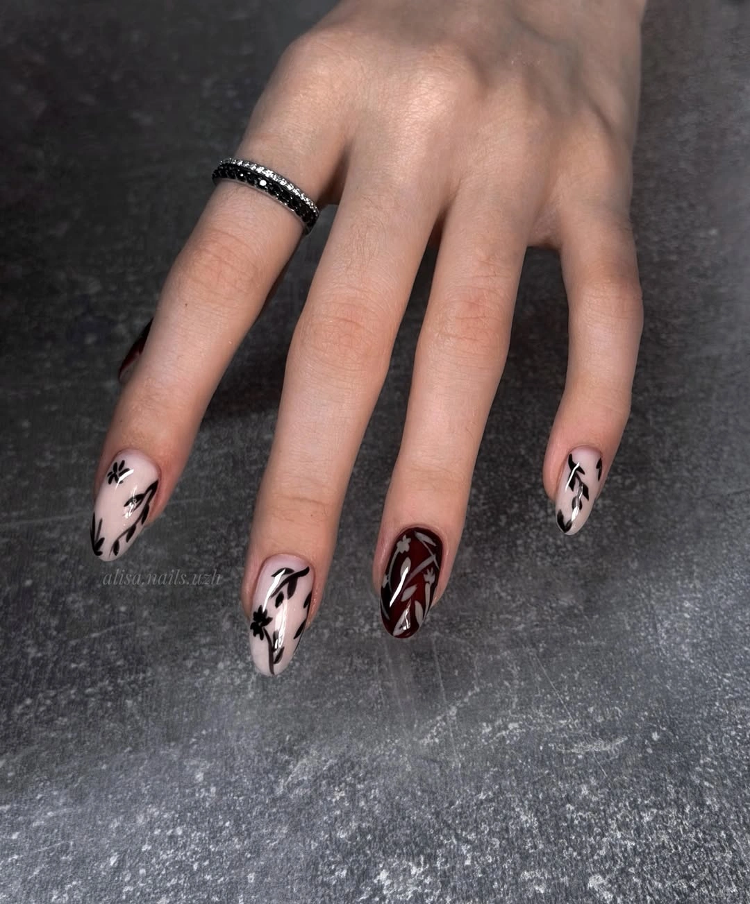 Blush almond nails with irregular black web line accents