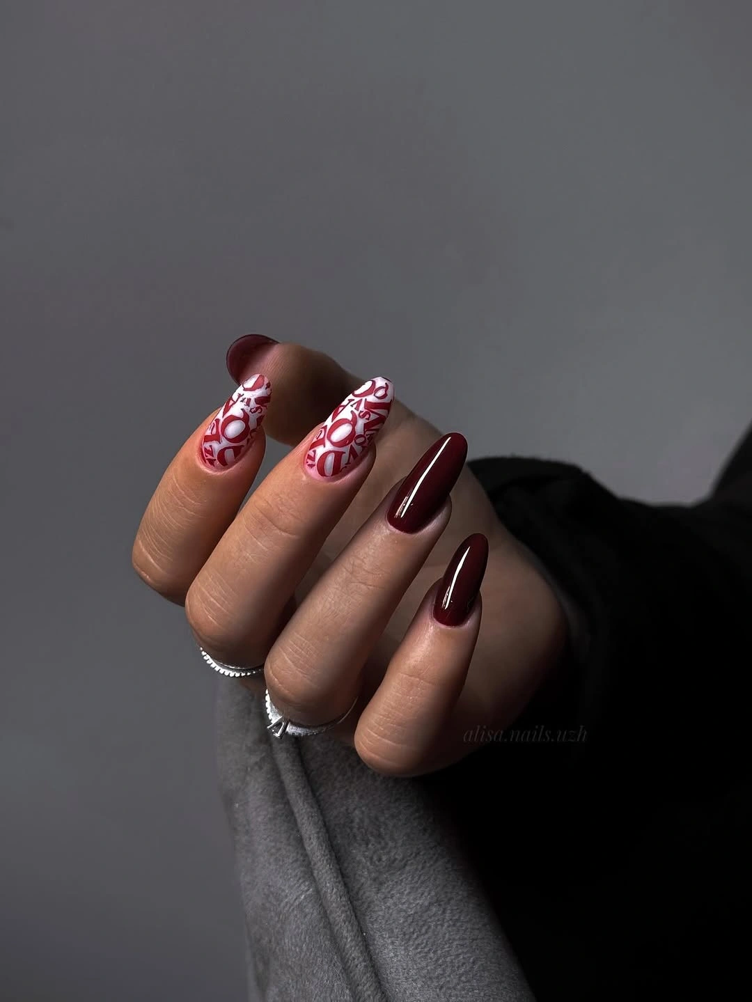 Long almond nails with berry pink and white curved accents
