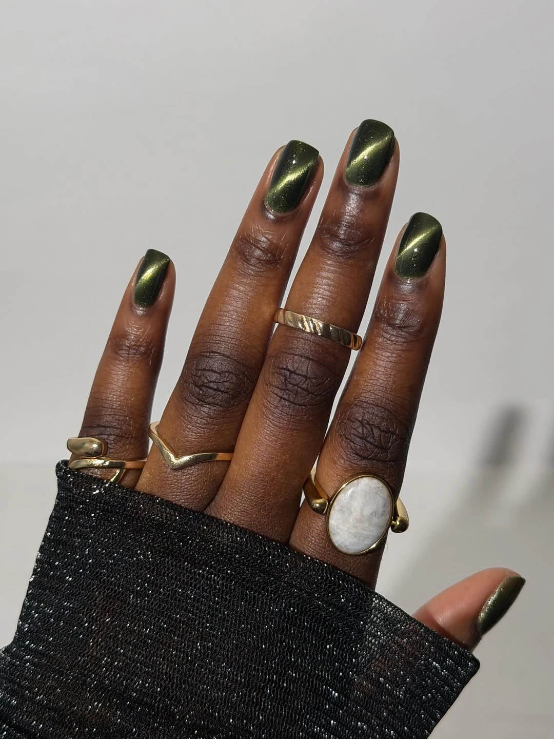 Short deep olive green nails with a reflective highlight