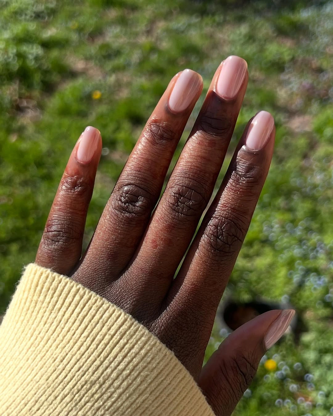 Short sheer blush pink nails with a glossy finish