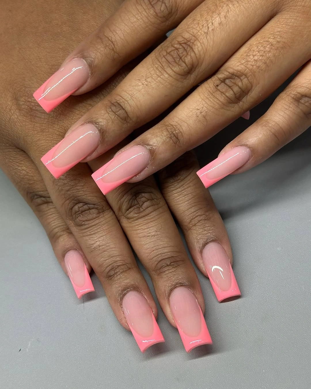 Soft pink square nails with bright hot pink French tips