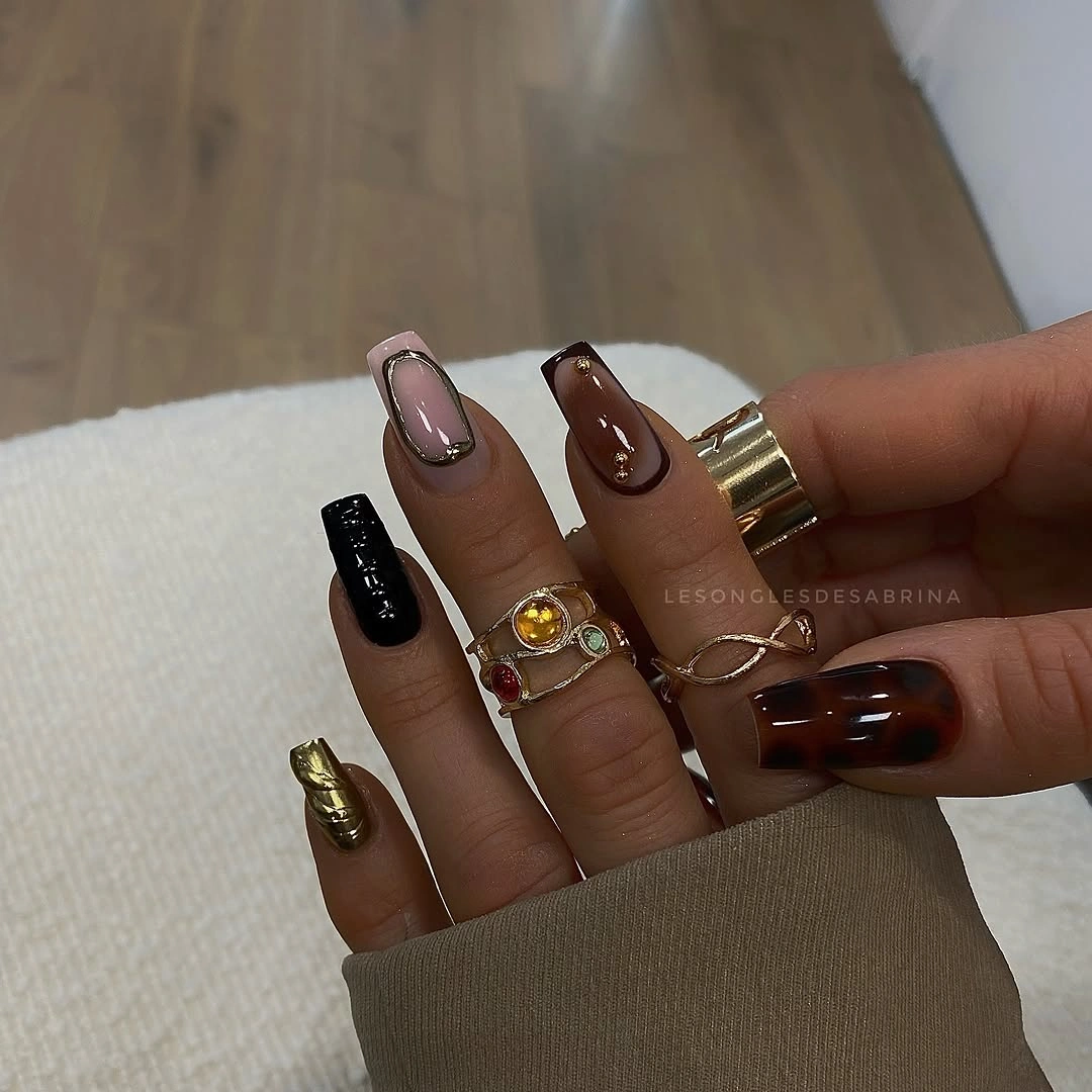 Medium almond nails in nude brown black and gold tones