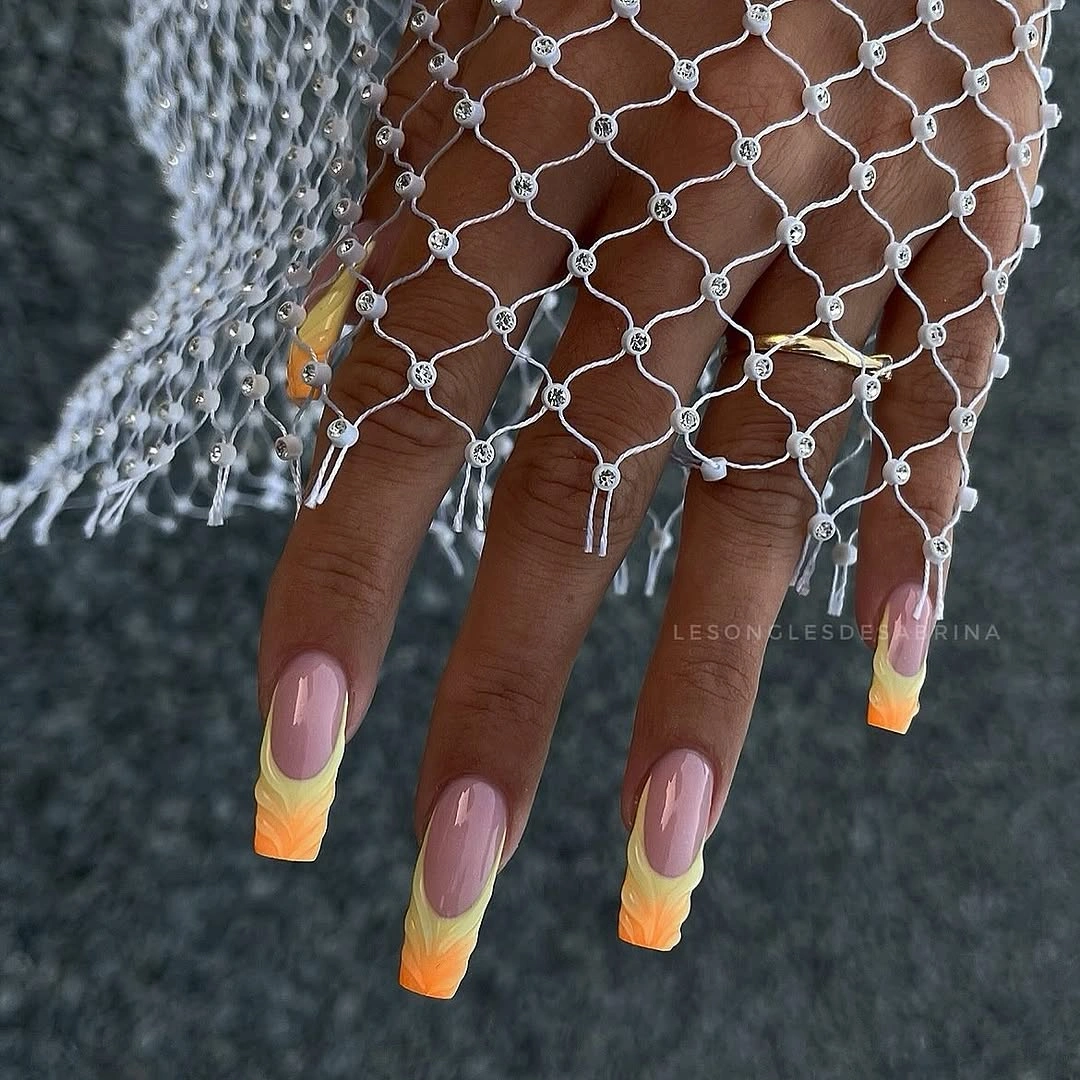 Long lavender almond nails with bright yellow orange tips